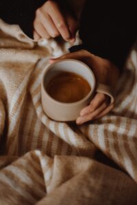 Coffee in mug on the bed